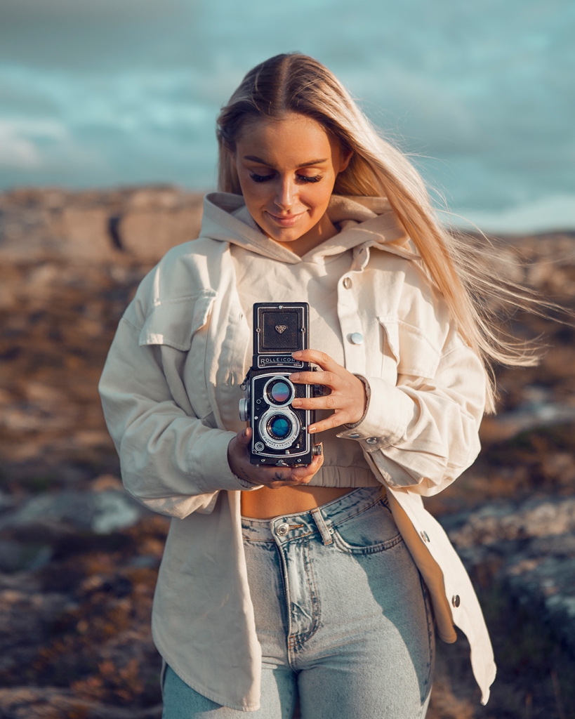 beautiful young norwegian girl holding vintage camera